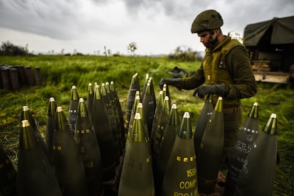 serviceman inspecting ammunition